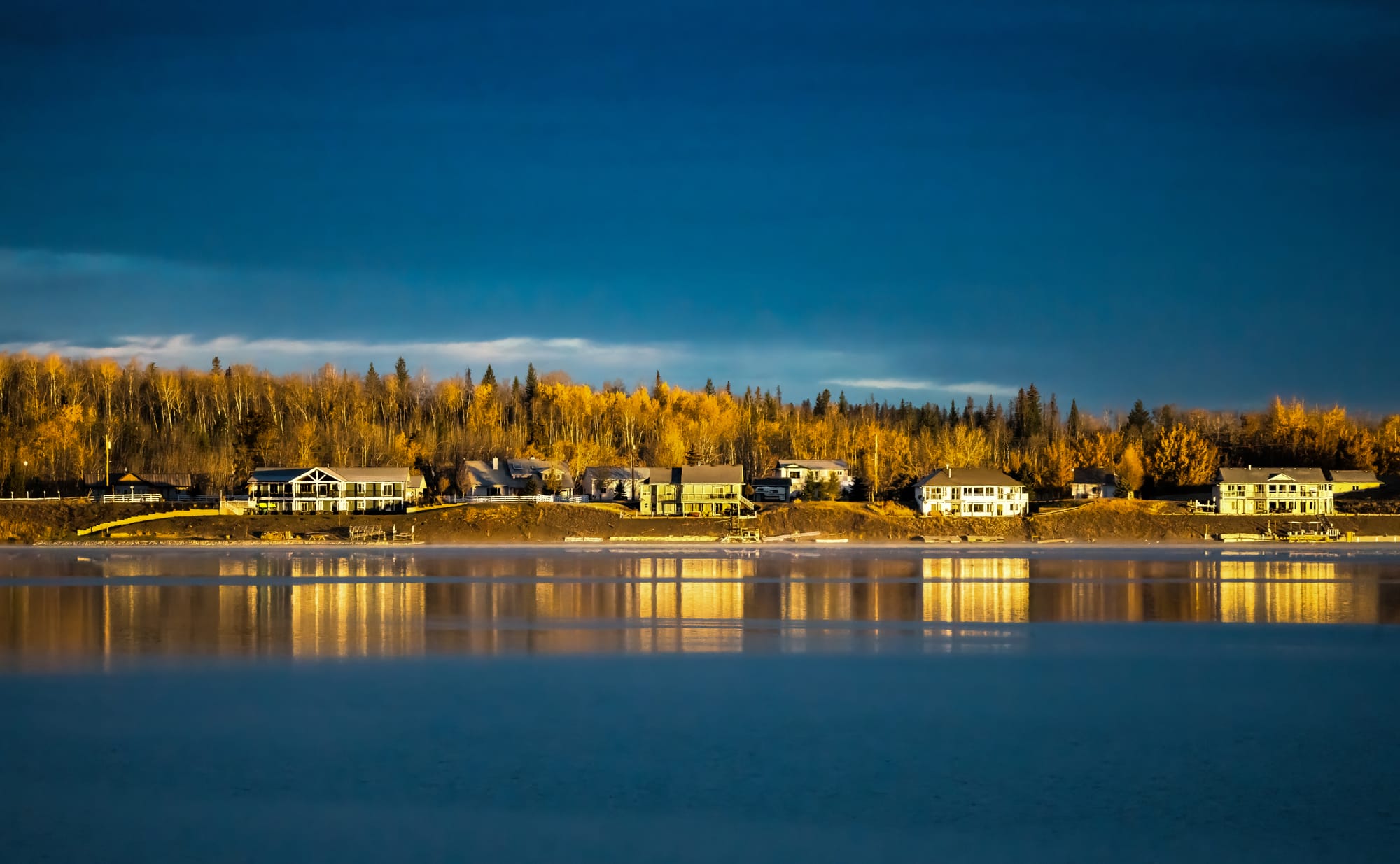 Golden-hour light on the north shore of Green Lake, houses and autumn aspens reflected in still water
